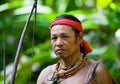 Man hunter Mentawai tribe with a bow and arrow in the jungle.